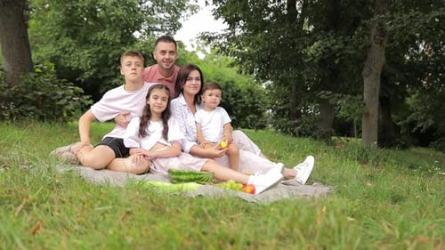 Family with Children Enjoying a Picnic in a Spring Garden Camping Recreation Hiking