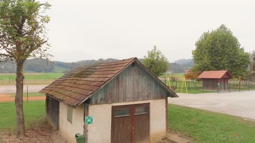 A drone view over an old hut with the basketball court in a village in a beautiful and mesmerizing v