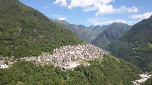 Drone shot of an Italian Village in the green mountain ranges of Dolomites, Premana Italy, 4k