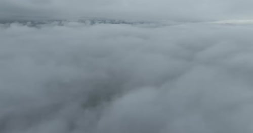 Aerial View Above Dense White Puffy Clouds
