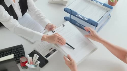 Senior Woman Signing Insurance Papers Top View