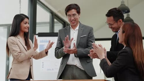 Diverse Team Applauds Success in Bright Workplace