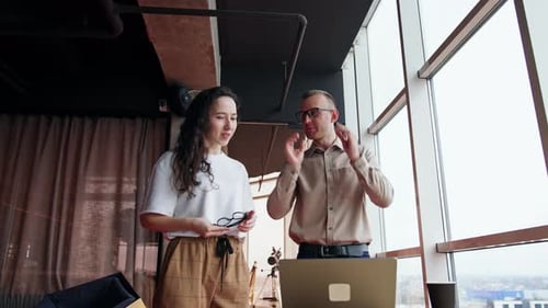 Office employees discussing the project on the laptop.