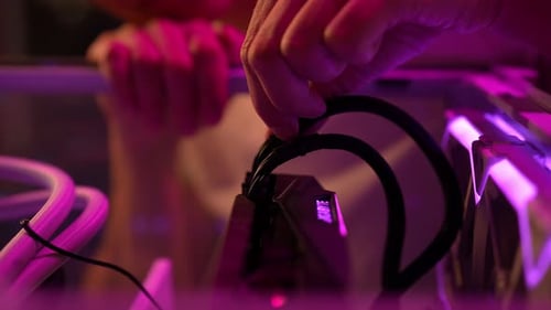 Hands Assembling Computer in a Home Setting