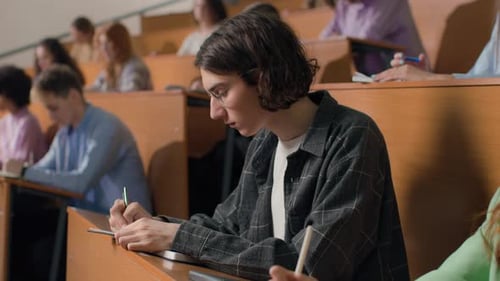 Students learning together in university lecture hall modern education