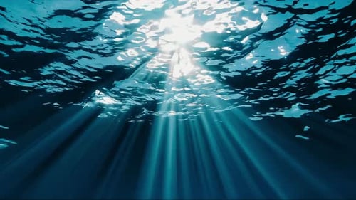 Sunlight is Magnificently Beaming Through the Enchanting Ocean Waves Creating a Serene Atmosphere