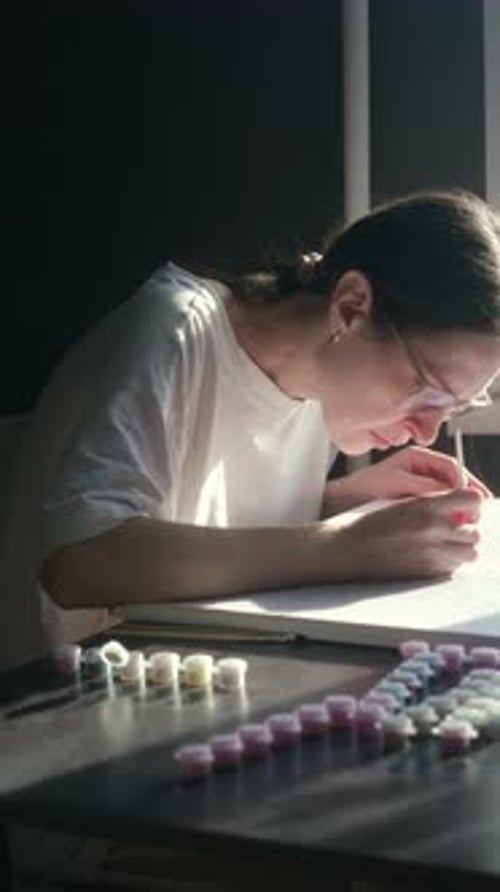 Young Woman Painting by Numbers in a Home
