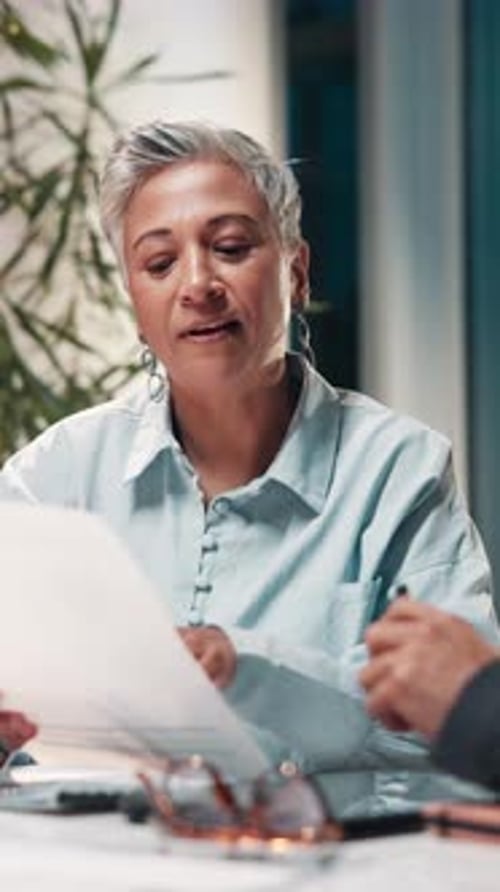 Woman, documents and meeting at night with review, feedback and planning at company