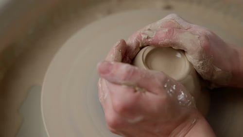 Hands Shaping Clay on Pottery Wheel