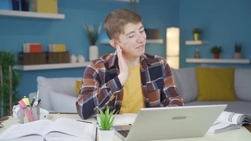 Young Adult Studying Hard With Laptop at Home