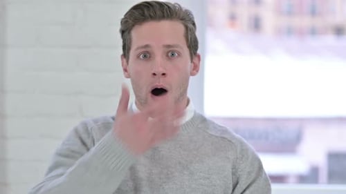 Man Reacts with Shock and Surprise