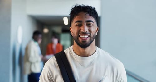 Smiling Young Adult Man with Backpack in Hallway