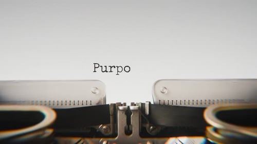 Old mechanical typewriter typing Purpose Of Living in a close-up view.