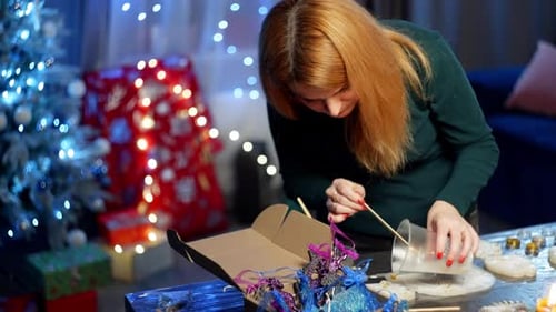 Woman Making Christmas Decorations at Home