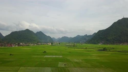 Panoramic Aerial View of Bac Son Valley's Lush Green Fields and Mountains