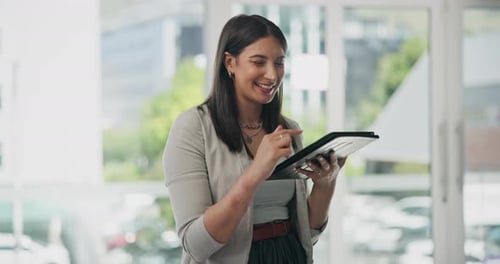 Woman Interacts With Tablet Device in Modern Office