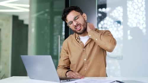 Young Man with Neck Pain at Computer