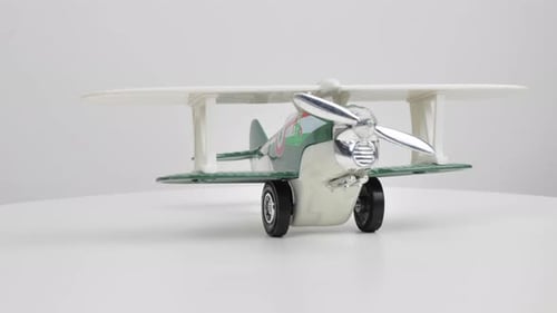 Toy Airplane on Wheels on White Surface