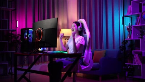 Teen Girl Celebrates Gaming Victory in Colorful Room