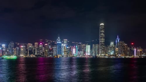 Nighttime Skyline Timelapse of Hong Kong with Illuminated Skyscrapers and Vibrant Waters