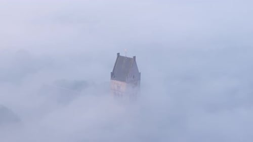 Aerial view of foggy sunrise over Martinikerk church, Netherlands.