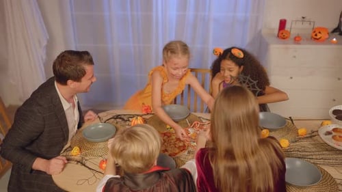 Family Halloween Celebration with Candy and Pizza
