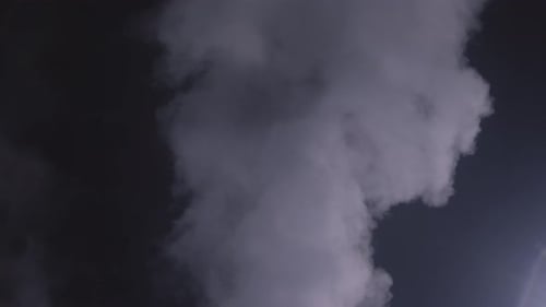 Swirling Grayish-White Smoke Against a Dark Background