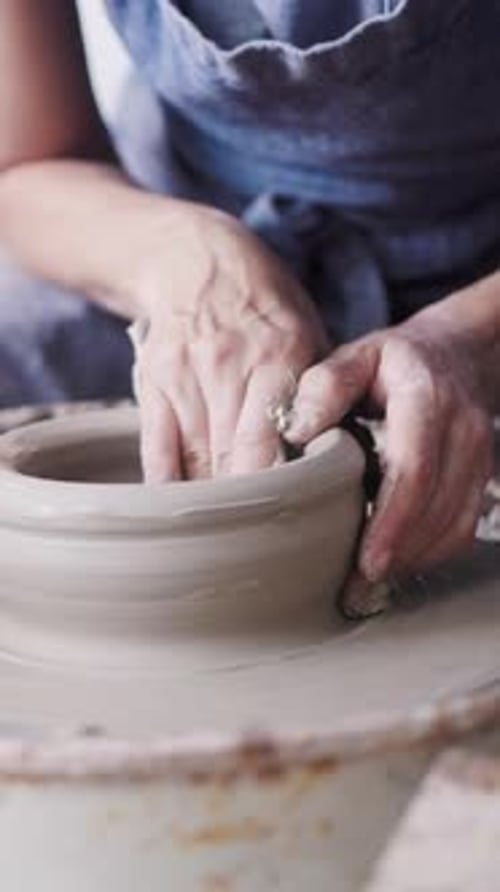 Pottery wheel, Hands work on ceramic clay workshop store. Small business. Vertical video