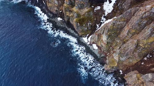 Flying Over Rocky Coastline Rocky Coast of the North Atlantic Ocean in Iceland