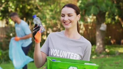 Volunteers Pick Up Plastic Bottles in Field