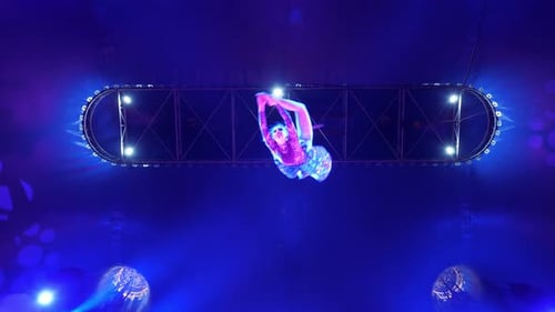 Aerial Acrobat Performs Under Blue Stage Lights