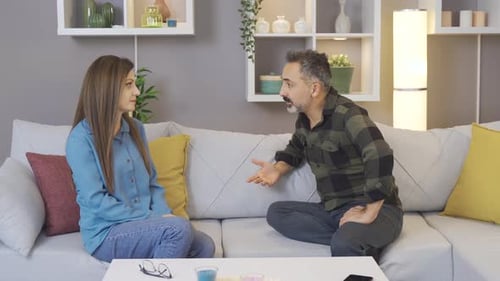 Couple Arguing on Couch Indoors