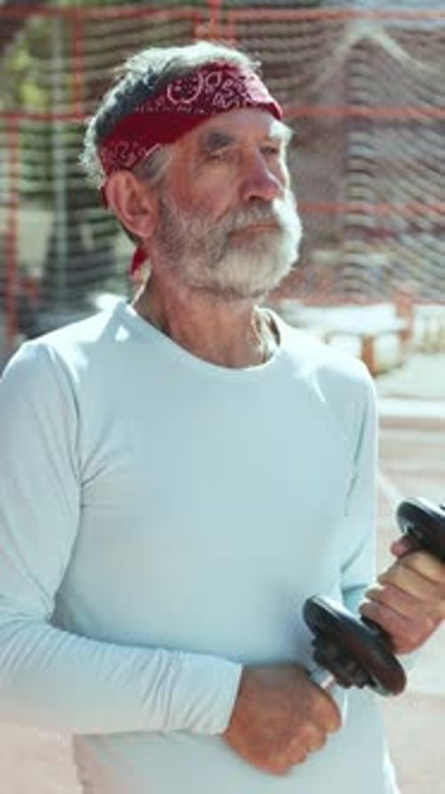Senior Man Lifting Weights Outdoors