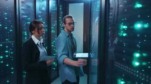 Engineers Inspecting Data Servers in Futuristic Room