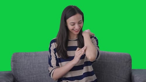 Happy Indian girl removing the bandage Green screen