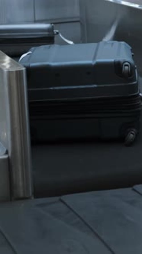 Suitcases Glide on Moving Airport Belt