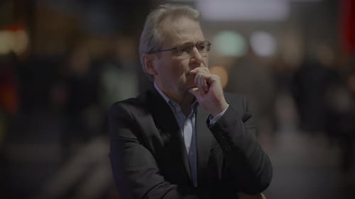 Man in Suit Thinking in Crowded Urban Space