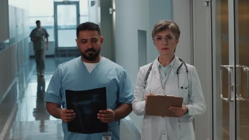 Portrait of Male and Female Doctors during Workday in Hospital