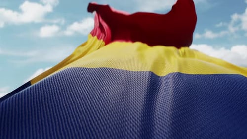 Red Yellow Blue Striped Flag Waving Against Blue Sky