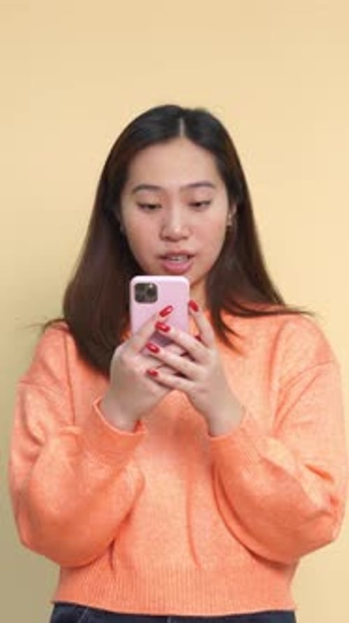 Young Woman Surprised by Content on Mobile Phone