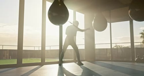 Fitness, boxing and woman training with a punching bag for a fight, match or competition in gym