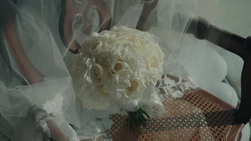 Wedding Bouquet and Veil on Antique Wooden Chair