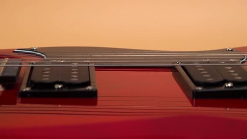 Six-string electric guitar. The camera moves to the rhythm of the guitar.