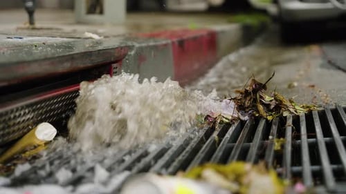A Storm Drain Flooding on the Street with a Waterfall, Slow Motion.