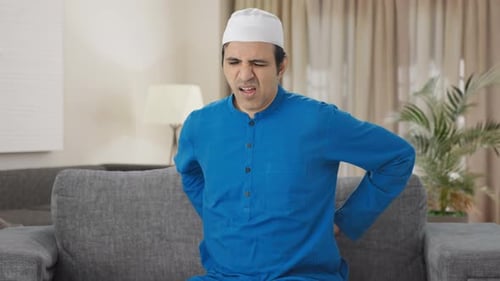 Man Experiencing Back and Abdominal Pain