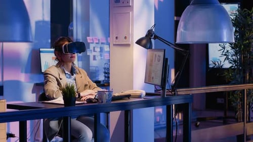 Young Worker Wearing Virtual Reality Goggles in Office