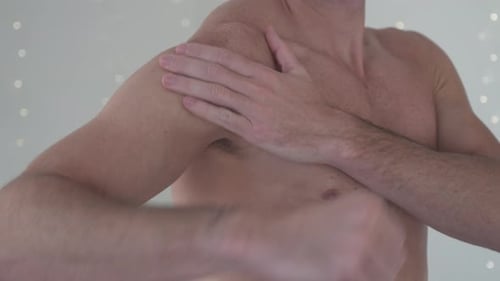 Man Massaging His Shoulder and Arm Muscles