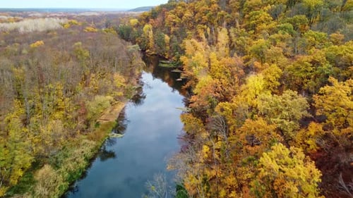 Autumn aerial above river with colorful riverbanks