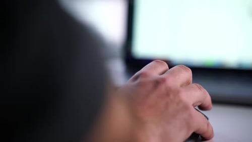 working on computer with mouse in office