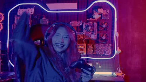 Woman Playing Video Games and Celebrates Victory